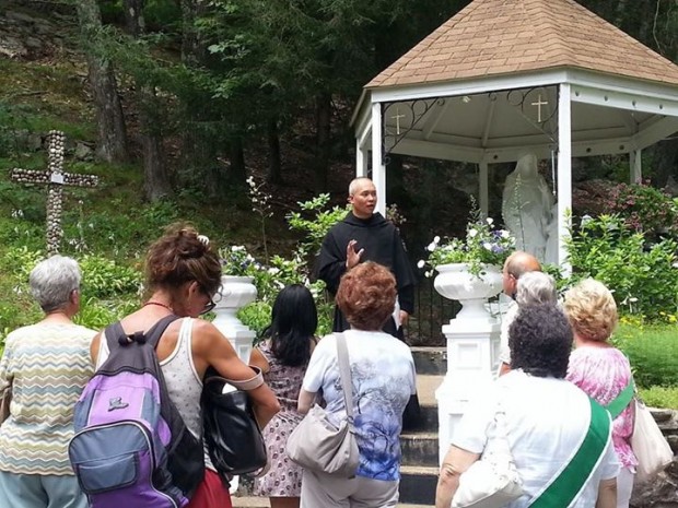 Fr. Dinh Vo Tran, A.A., shrine director, speaks to pilgrims